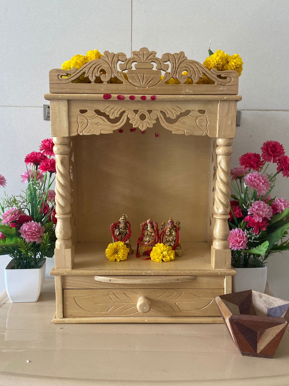 Beautiful wooden prayer shrine with flowers